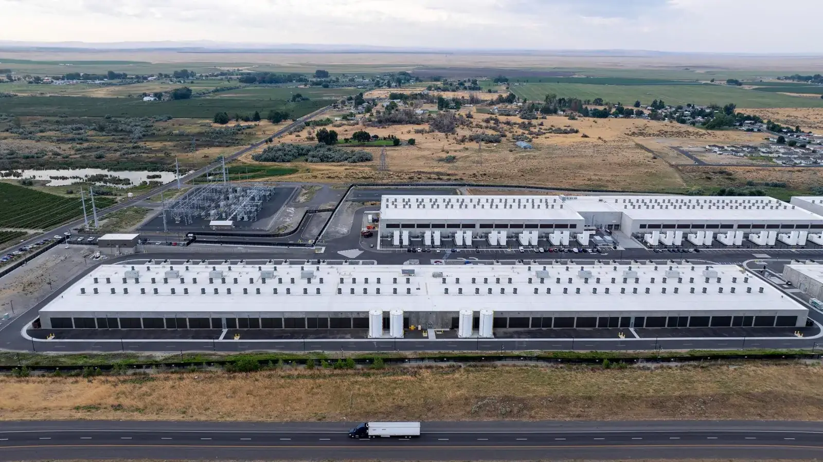 Luchtfoto van grote datacenterhallen van Amazon tussen akkerland in Morrow County, Oregon