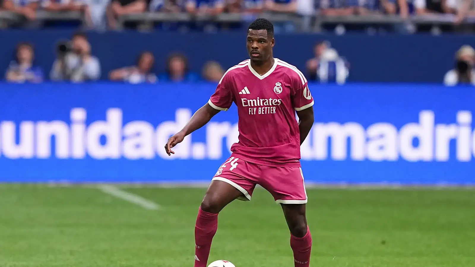 Denzel Dumfries aan de bal in het roze Real Madrid-uitshirt met rugnummer 24, met wazige tribunes op de achtergrond