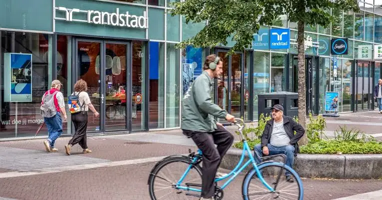 Vestiging van uitzendbureau Randstad aan een winkelstraat met voorbijgangers